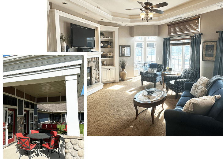 Interior living room with large windows, beige carpet, dark blue sofa with pillows, armchairs, a coffee table, built-in shelves around a fireplace, and ceiling fan. Smaller outdoor patio with red chairs and table, covered by a roof, attached to the building.
